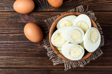 Boiled eggs on dark wooden background.