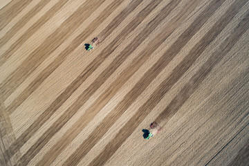 Tractor plowing farm field in preparation for spring planting