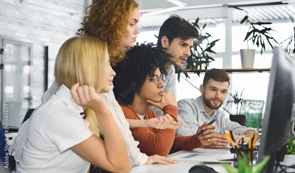 Poster pensive millennial team reading business information on computer