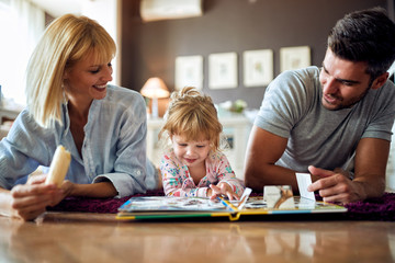 Happy family with cute kid playing