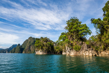 Naklejka premium Beautiful nature rock mountains cliff and blue emerald water color lake river with blue clear sky in Ratchaprapa Dam at Khao Sok National Park, Surat Thani Province, Thailand. Asia tourism location.