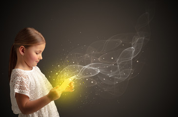 Little cute girl playing on sparkling tablet
