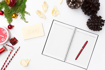 Christmas composition, notebook open pages, pen, fir branches on white background. Christmas, winter, new year concept. Flat lay, top view, copy spa