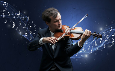 Fototapeta premium Lonely musical composer with violin and sparkling musical notes around