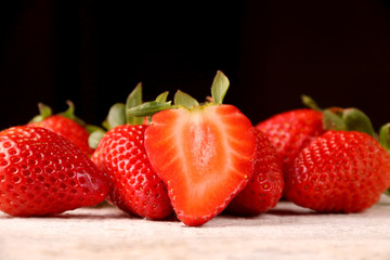 Healthy Heap of fresh strawberries on white wooden background.