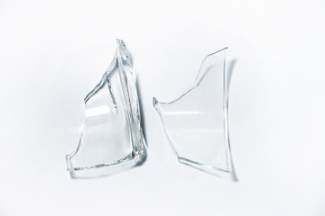Parts of the broken cup jar glass isolated on white background. Pieces of sharp broken glass....