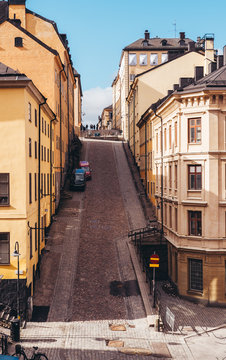 Steep and narrow cobblestone street with old buildings in Stockholm Sweden