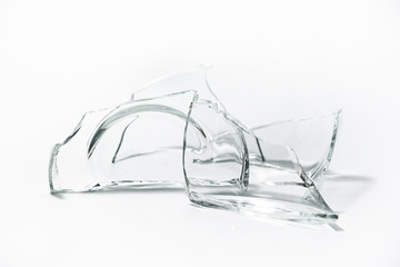 Parts of the broken cup jar glass isolated on white background. Pieces of sharp broken glass....