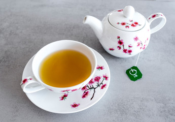 Traditional modern and elegant china tea service with tea bag on the grey table