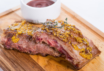grilled spare ribs.with sauce on a wooden board