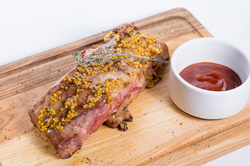 grilled spare ribs.with sauce on a wooden board