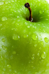 Green apple with water drops