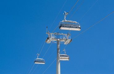 Chairlifts at blue sky background