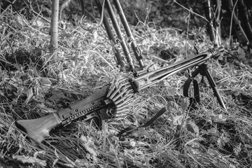 World War II German Wehrmacht Infantry Soldier Army Weapon. MG 42 Machine Gun On Ground In Forest Trench. WWII WW2 German Ammunition. Photo In Black And White Colors