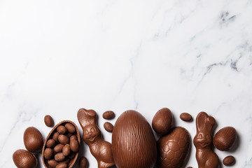 Chocolate easter eggs and bunnies on a marble background