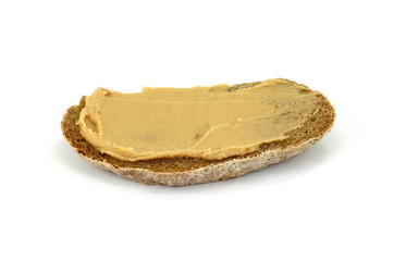 Peanut butter on a slice of homemade multigrain bread.