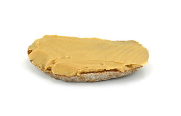 Peanut butter on a slice of homemade multigrain bread.