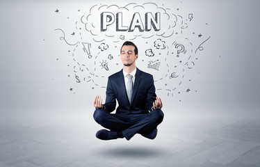 Businessman sitting in yoga position and meditates with doodle concept
