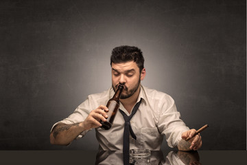 Young drunk man at his office with free dark copyspace