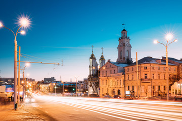 Fototapeta na wymiar Vitebsk, Belarus. Traffic At Lenina Street, Holy Resurrection Church And City Hall In Evening Or Night Illumination At Winter