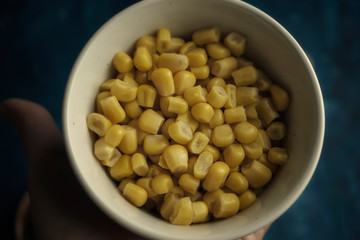 Sweet cnned corn in white bowl. Vegetarian snack