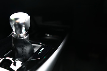 Automatic transmission gear on dark background.Modern new car interior,Close up of metallic silver Gearstick.Technology,Vehicle,Automobile Concept.