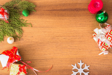 Christmas composition. Christmas gift, pine cones, fir branches on wooden golden background. Flat lay, top view