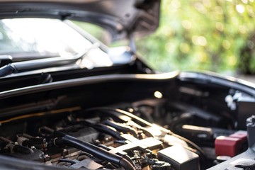 Powerful car engine on green bokeh sunlight background. Internal design of engine. Automobile metal new car engine part details.Concept of modern vehicle motor,Industry,Mechanic and Business.