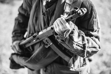 Woman Re-enactor Dressed As World War Ii Soviet Russian Red Army Soldier Holding World War II Weapon Submachine Gun Pps-43. WWII WW2 Russian Ammunition. Photo In Black And White Colors