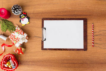 notes to do list Christmas composition. Christmas gift, pine cones, fir branches on wooden white background. Flat lay, top view