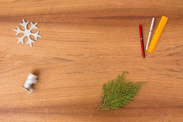 Christmas composition. Christmas gift, pine cones, fir branches on wooden golden background. Flat lay, top view