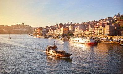 Fototapeta premium Portugal, Porto old town ribeira aerial promenade view with colorful houses, Douro river and boats.Concept of world travel, sightseeing and tourism