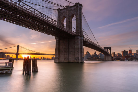 Brooklyn Bridge at sunrise from East River with long exposure photo