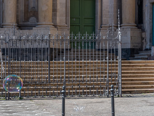 Bubble Floating by a Fence in an Italian City in Sicily