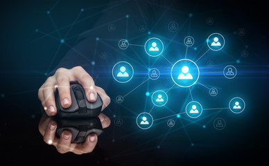 Hand using wireless mouse in a dark environment with human network concept