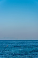 Tiny Fishing Boat on the Blue Italian Mediterranean Sea on a Clear Sunny Day