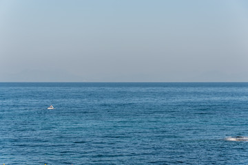 Obraz premium Tiny Fishing Boat on the Blue Italian Mediterranean Sea on a Clear Sunny Day