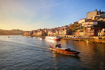 Obraz premium Portugal, Porto old town ribeira aerial promenade view with colorful houses, Douro river and boats.Concept of world travel, sightseeing and tourism
