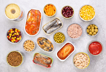 Canned food on stone background, top view - obrazy, fototapety, plakaty