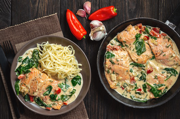 Salmon baked in cream sauce with spinach and bel pepper. 