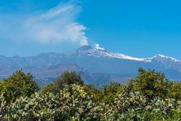 Fototapeta premium Mt. Etna Volcano Emitting Smoke on a Sunny Day