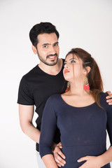 young couple together posing on white background