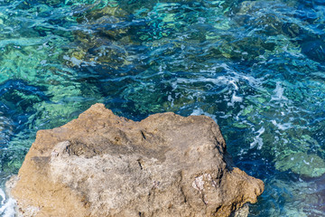Rock in the Turquoise Blue Green Clear Mediterranean Sea in Southern Italy