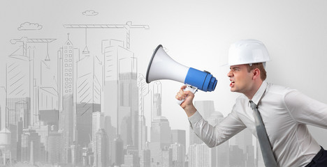 Fototapeta premium Young supervisor architect yelling to a big city panorama 