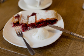 strudel with cherries. Cutlery fork and knife. dessert with tea