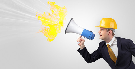 Fototapeta premium Young architect constructor yelling with megaphone with copyspace