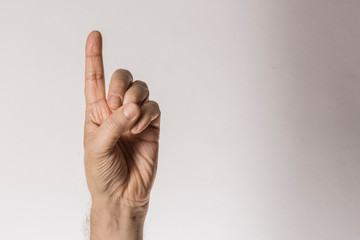 man's hand gesture, counting number one, isolated on white background