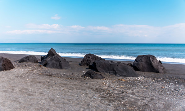 Volcanic Black Sand Beach and Blue Ionian Sea in Sicily