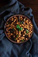 Chickpeas with fried eggplants, garlic, zira and paprika. Eastern cuisine., top view.