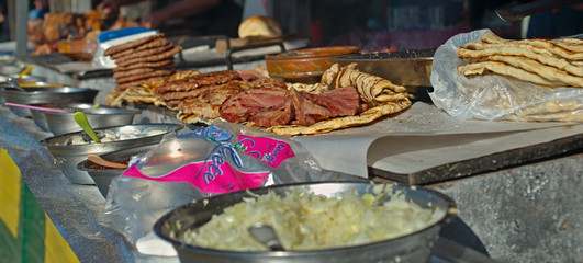 Barbeque stand with bunch of different prepared meats Barbeque stand with bunch of different prepared meats, closeup